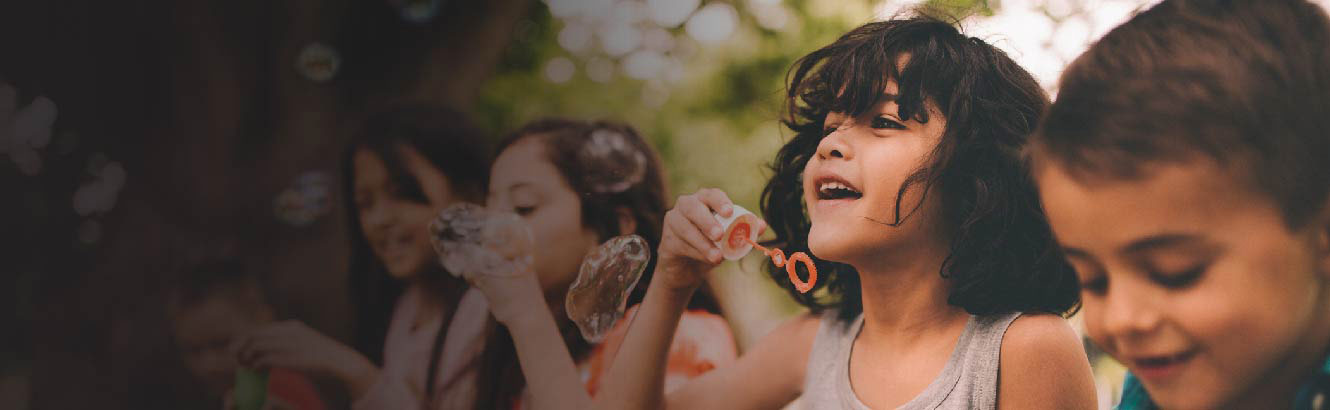 Children playing and blowing bubbles